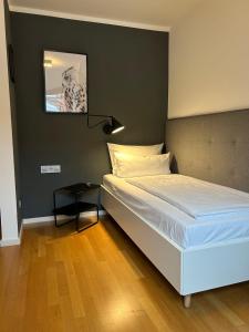 Postel nebo postele na pokoji v ubytování DK Hotel Heidelberg