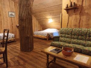 a living room with a couch and a bed at Hobbit Mont Saint Michel Castel Brandy in Tanis