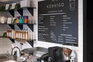 a menu on the wall of a coffee shop at Kennigo Hotel Brisbane, Independent Collection by EVT in Brisbane