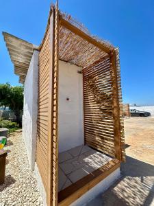 a small wooden building with a roof on a beach at Villa Santo Stefano in Monopoli