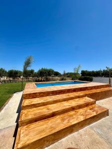 a wooden retaining wall around a swimming pool at Villa Santo Stefano in Monopoli