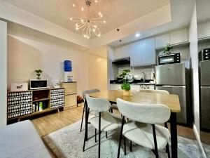 a kitchen and dining room with a table and chairs at Studio Type Condo City View 23rd F Abreeza Place in Davao City