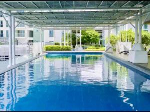 uma piscina com água azul num edifício em Studio Type Condo City View 23rd F Abreeza Place em Davao