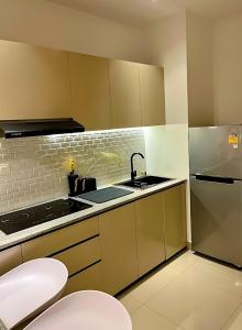 a small kitchen with a sink and a stove at Negombo Ocean View Luxury Studio by Serendib Vacation in Negombo