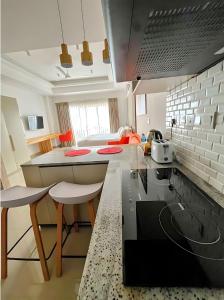 a kitchen with a table and some chairs in a room at Negombo Ocean View Luxury Studio by Serendib Vacation in Negombo