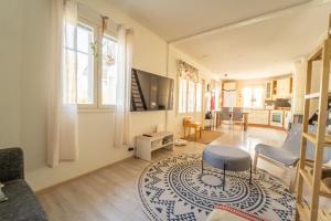 a living room with a television and a rug at Aidattu omakotitalo - Palju lisämaksusta in Kalajoki
