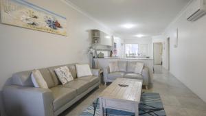 a living room with a couch and a coffee table at Apartment 5 - The Meridian in Old Bar