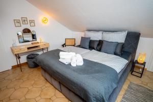 a bedroom with a large bed with towels on it at Boutique Apartment Niederrhein in Friedrichsfeld