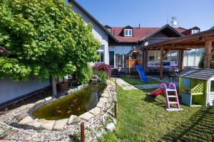 a backyard with a pond and a playground at Hotel & SPA centrum PALMIRA in Uherský Brod