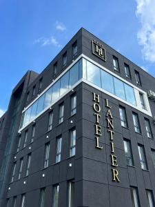 a black building with a clock on top of it at Hotel Lantier Bytom - Katowice - Chorzów in Bytom