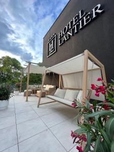 a patio with a bed under a canopy in front of a building at Hotel Lantier Bytom - Katowice - Chorzów in Bytom