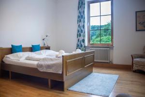a bedroom with a bed and a large window at Trend Lokal-Rooms-Bar in Frohnleiten