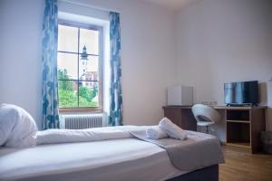 a hotel room with a bed and a window at Trend Lokal-Rooms-Bar in Frohnleiten