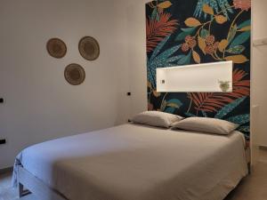 a bedroom with a bed with a wall mural at Le Terrazze in Tropea