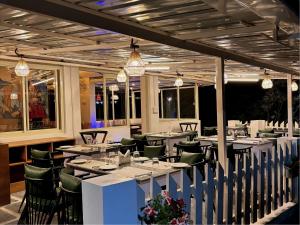 a restaurant with long tables and chairs and lights at Mountain Vieww Retrreat at Indrunag in Dharamshala