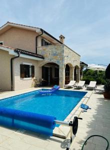 a swimming pool in front of a house at Villa Seaside in Krk