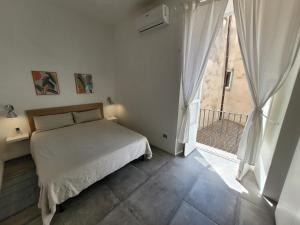 a bedroom with a bed and a large window at Le Terrazze in Tropea