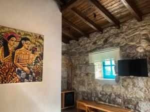 a painting on the wall of a room with a table at Casa Alegre Alaçatı in Alaçatı