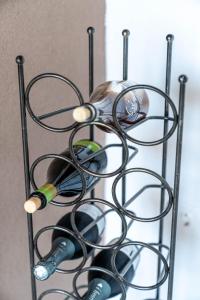 a rack of wine glasses and wine bottles at Christiana's Cottage in Sidari