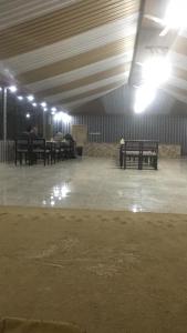 a room with benches and lights in a building at Salma Desert Camp in Disah