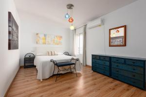 a bedroom with a bed and a blue dresser at Manilva Home in San Luis de Sabinillas