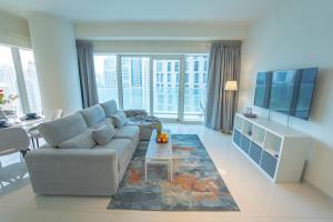 a living room with a couch and a table at AWS Homes - Unique High View at Damac Heights in Dubai