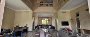 a large living room with couches and a tv at Villa Ayada in Marrakech
