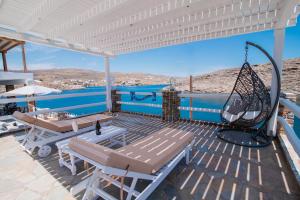 a porch with a swing and a swing at KL , Cozy Suite II in Kithnos