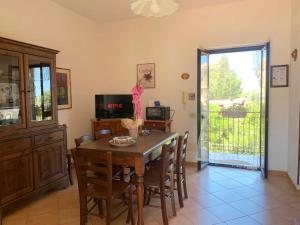 a dining room with a wooden table and chairs at Villa Maria in Castel di Tusa