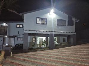 a large white house with a porch at night at The Haven: Make our Home your Home in Estcourt