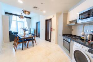 a kitchen and dining room with a table and a stove at AWS Homes - Supreme Retreat in Business Bay in Dubai
