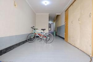 a bike parked in a hallway next to a wall at Wisma 812 Khusus Putra for Male Only in Bandung