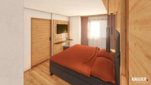 邁爾霍芬的住宿－Montana Apartments，一间卧室配有一张带橙色毯子的床