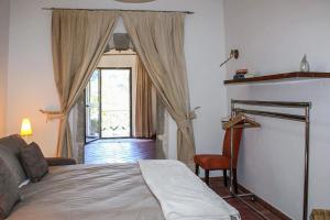 a bedroom with a bed and a large window at Antica Cantina Emilia in Reggio di Calabria