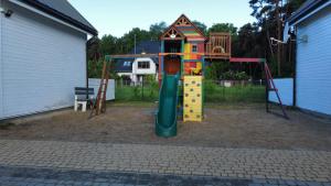 a playground with a slide and a play structure at TuNa in Dziwnów