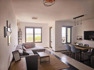 a living room with a couch and a table at Sea Vacation Homes in Chernomorets