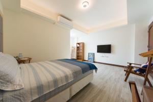 台东一品苑民宿的一间带床和平板电视的卧室
