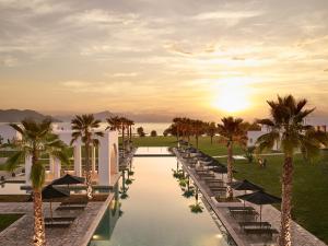 a rendering of a resort pool with palm trees at Grecotel Casa Marron in Kalamákion +107 photos
