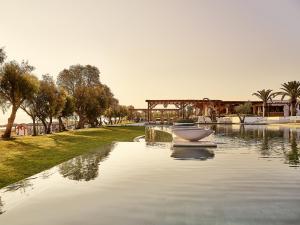 a boat in the middle of a body of water at Grecotel Casa Marron in Kalamákion
