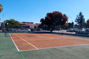 una pista de tenis con una red en un aparcamiento en Kampaoh Âncora en Vila Praia de Âncora