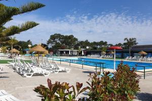a pool with white lounge chairs and a swimming pool at Kampaoh Âncora in Vila Praia de Âncora +47 photos