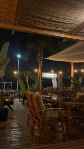 a restaurant with chairs and tables at night at Hotel Angel Beach - Kızkalesi Mersin in Erdemli