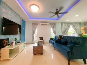 a living room with a blue couch and a tv at A05 Tebrau Austin 1 in Johor Bahru
