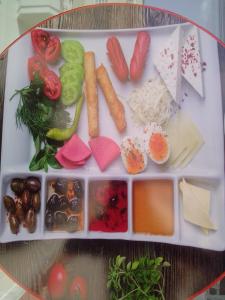 a tray of food with vegetables on a table at İSABELLA APART OTEL in Alanya