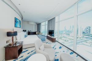 a hotel room with a bed and a large window at Century Marina Hotel - Lusail in Lusail