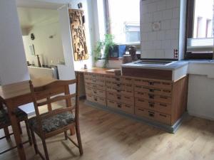 a kitchen with a sink and a bunch of drawers at Ferienwohnung-im-mauerbluemchen in Rostock