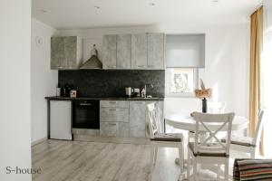 a kitchen with a table and chairs in a room at Vacation house in Saulkrasti