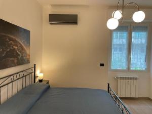 a bedroom with a bed and a large window at Casa Del Lupo in Genova