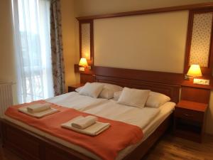 Postel nebo postele na pokoji v ubytování Mara Apartman