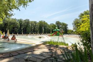 a water park with two people in the water slide at hu I Pini village in Fiano Romano